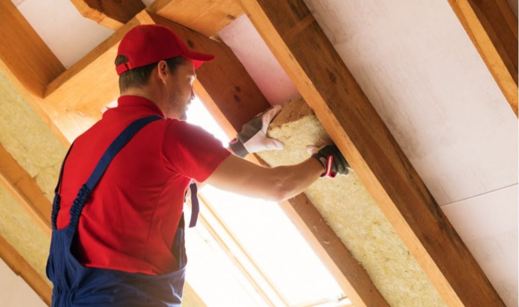 Image of a contractor insulating a wall